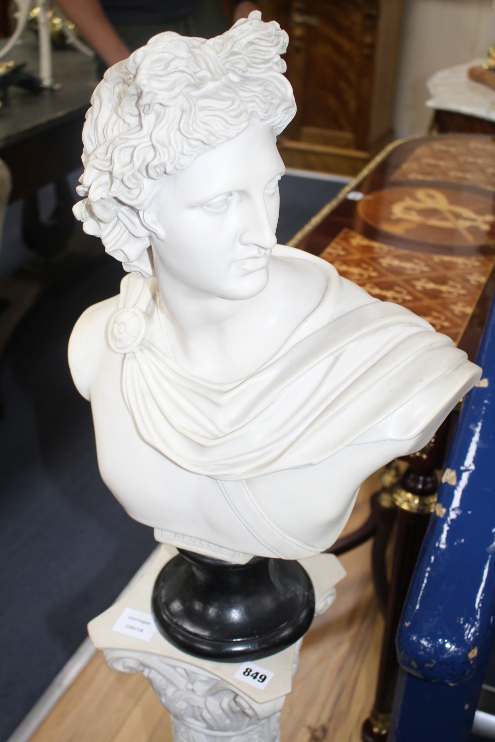 A composition faux marble bust of Apollo on a pedestal, overall H.128cm